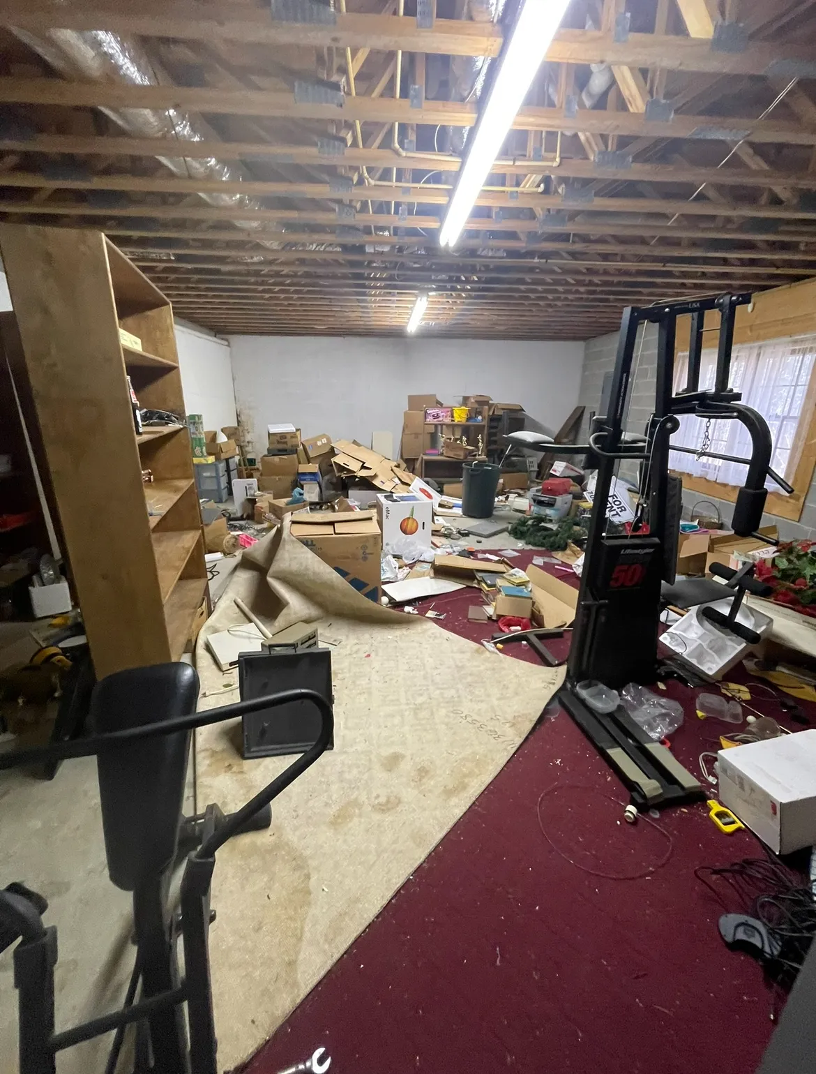 Basement with heavy equipment before junk removal
